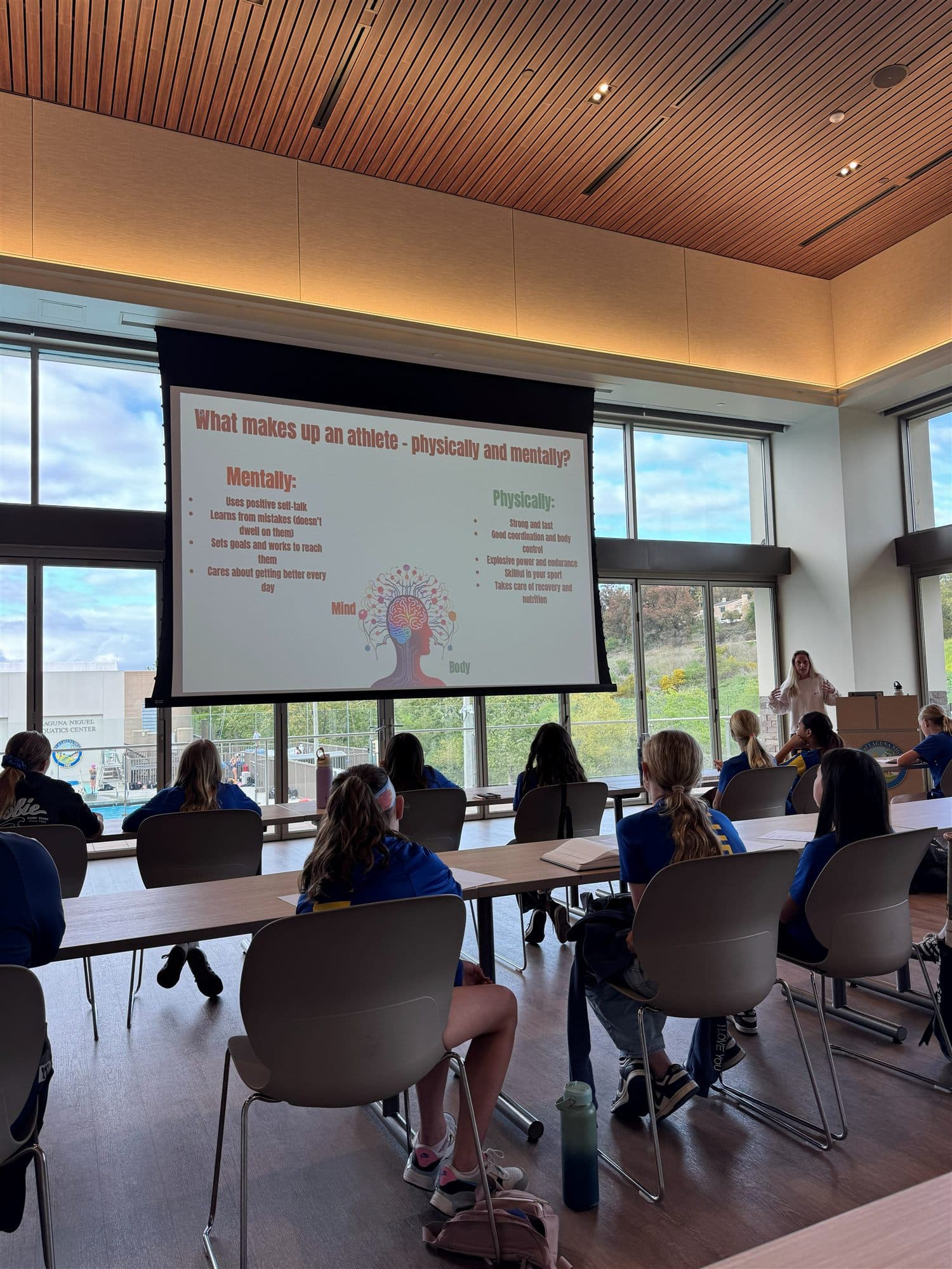 Coach Bella leading a mental training workshop with a girls' team