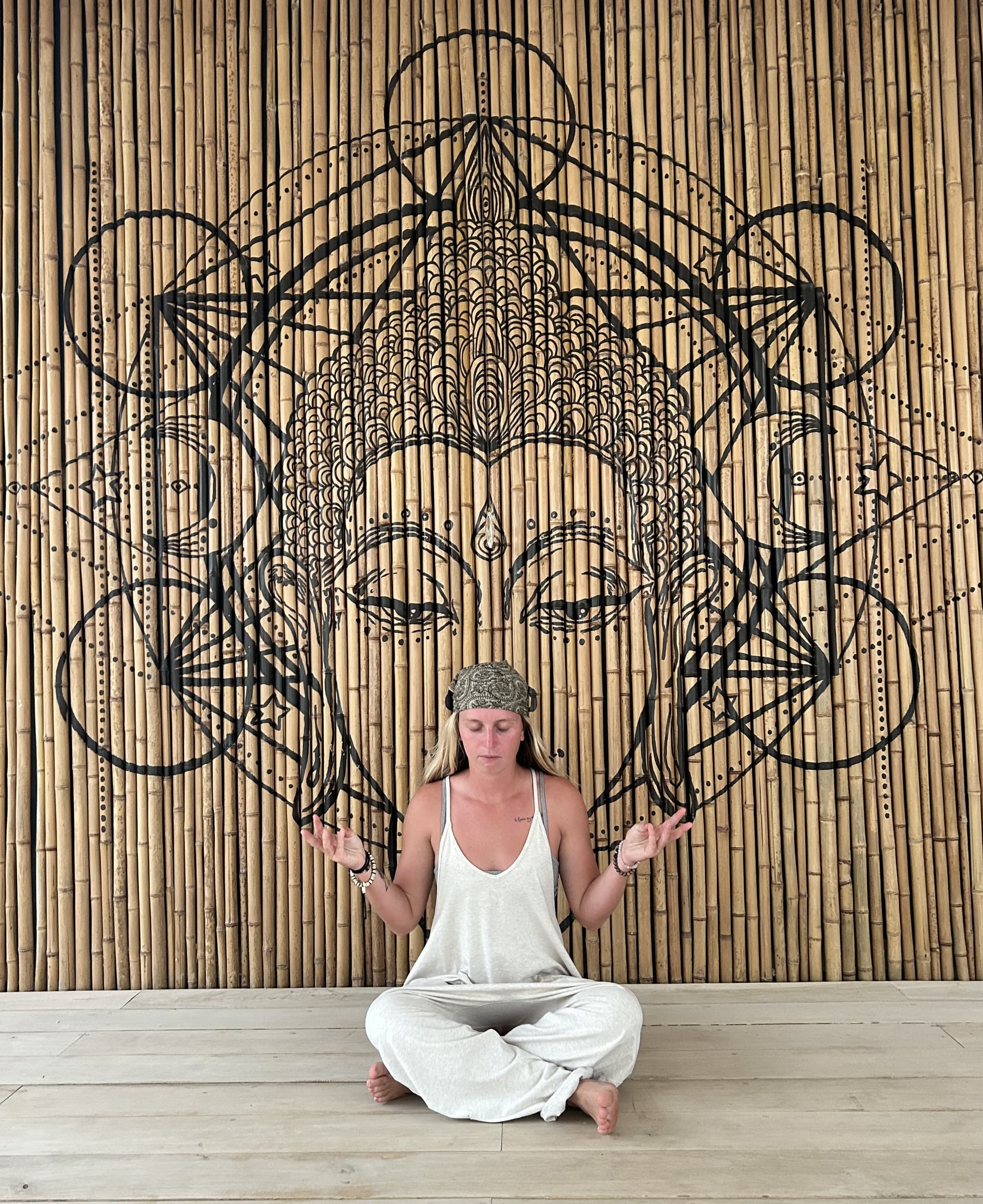 Coach Bella in a seated meditation pose